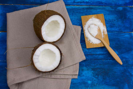 flat lay coconut and cocnut flakes  on a  blue wooden tableの写真素材