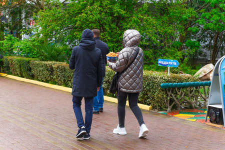 SOCHI,RUSSIA,  21 APRIL 2019 - couple of young tourists walking  in the Riviera park