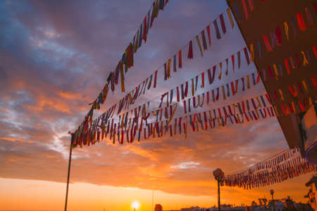 SOCHI,RUSSIA,  23 APRIL 2019 -  people on the waterfront at the  sunset ,the promenade decorated with flags in front of the sunset skyのeditorial素材