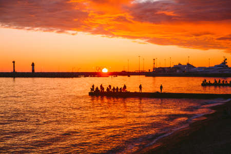 SOCHI,RUSSIA, 23 APRIL 2019 - sunset on the black sea,silhouettes of fishermen on the breakwatersのeditorial素材