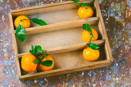 top view tangerines in a wooden boxの写真素材