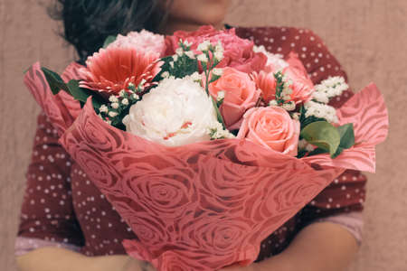 woman  with bouquet of gentle fresh flowersの写真素材