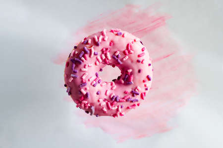 pink doughnut on a pastel watercolor backgroundの写真素材