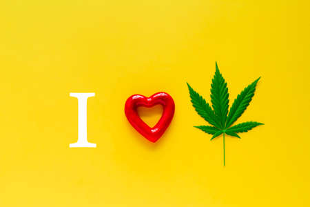 marijuana and red heart on a yellow background, i love marijuana concept