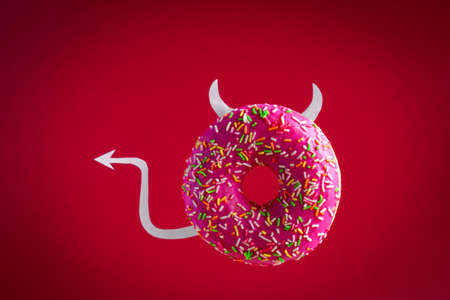 devil donut with paper horns and tail flying on red background