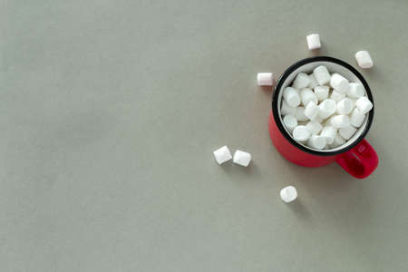 top view red cup with marshmallows on a gray background copy spaceの写真素材