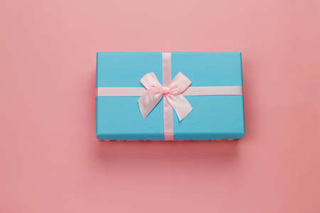 top view cute blue  present box on a pastel pink backgroundの写真素材
