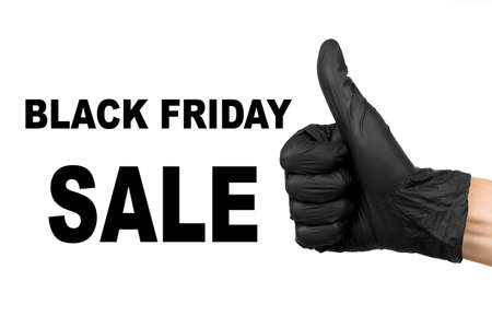 black friday sale inscription and hand in  black glove showing thumb up sign isolated on a white background big sale templateの写真素材