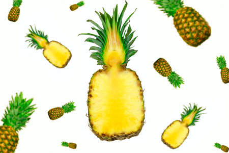 whole and half pineapples flying isolated on white backgroundの写真素材