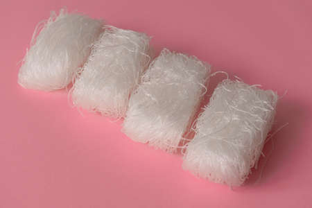 Asian uncooked cellophane noodles  on a pink background