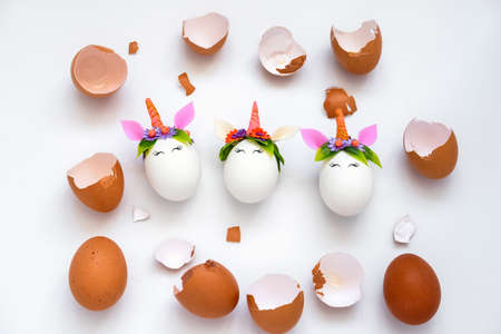 top view egg shell and Easter unicorn eggs pattern on a white background