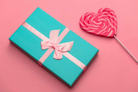 top view flat lay gift box and heart shaped caramel on a stick,selective focus