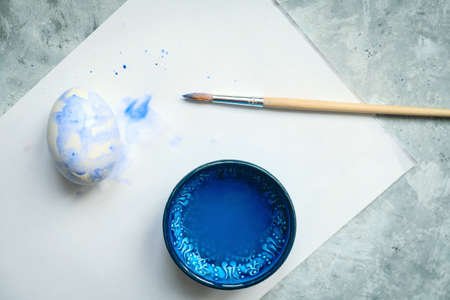 top view selective focus bowl  with blue dye, brush   painted eggs, painting eggs for Easter diy conceptの写真素材