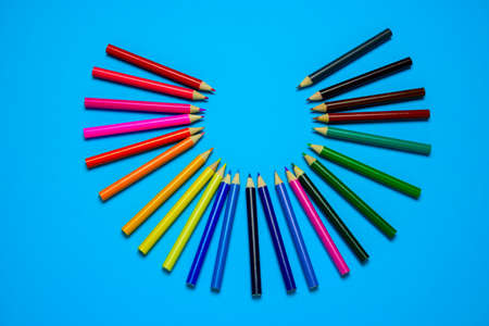 top view flat lay vibrant wooden multicolored pencils on a blue background