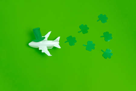 top view airplane with green hat and paper cut green leavesの写真素材