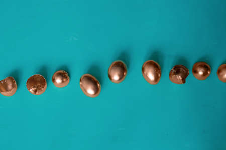 top view golden easter eggs and egg shells on a blue background