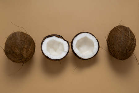 top view layout of fresh coconuts row on a brown background