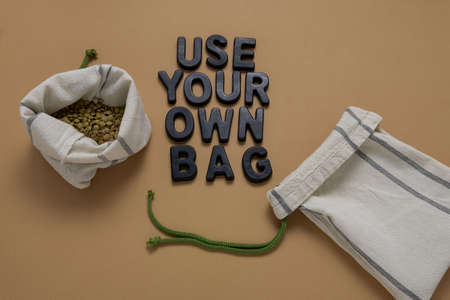 top view lentil in textile bag flat lay on a beige background, zero waste and no plastic bags conceptの写真素材