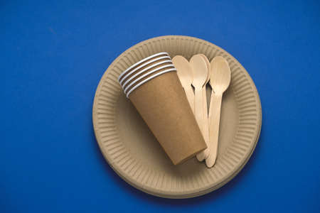 biodegradable tableware on a blue background, eco friendly lifestyle conceptの写真素材