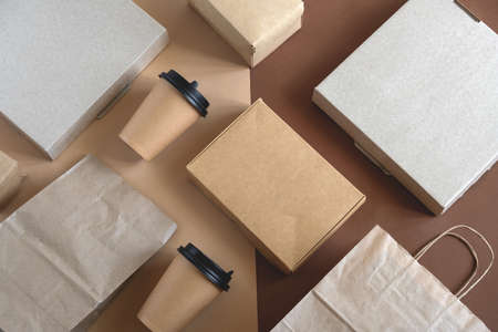 top view flat lay disposable blank delivery food packaging on a beige and brown backgroundの写真素材
