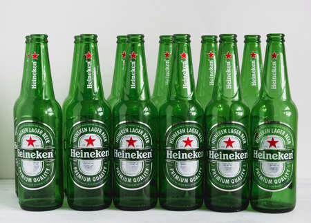 1 May , 2020, Saint Petersburg, Russia, close up of green empty beer bottles on a white backgroundのeditorial素材