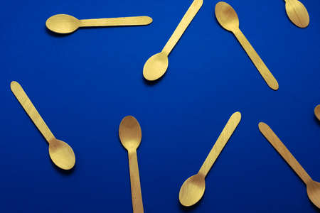 top view flat lay wooden spoons pattern  on a blue backgroundの写真素材