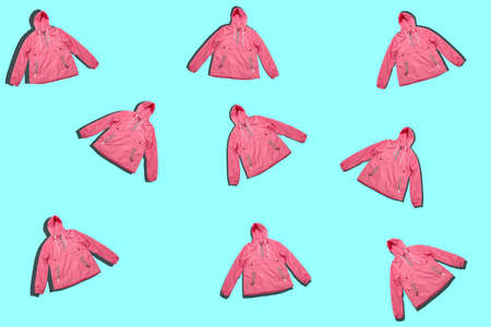 pattern of pink raincoats isolated on a blue background