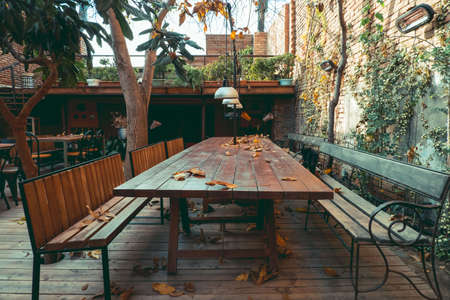 autumn patio with table and benches , seasonal autumn compositionの写真素材
