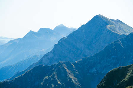blurred abstract natural background with Caucasus Mountains in a morning blue mistの写真素材