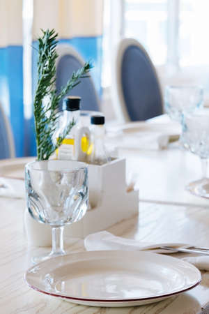 blurred background elegant table setting with white plate and crystal glassの写真素材