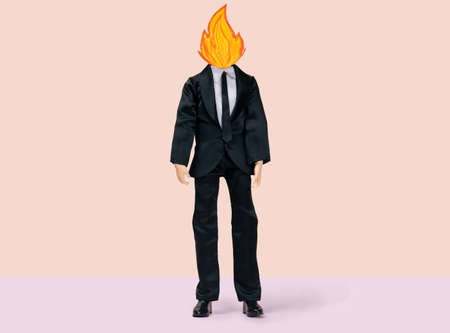 male doll in a business suit with fire instead of a head, stress and emotional burnout conceptの写真素材