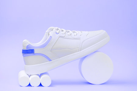 new trendy white sports sneaker on a stand, trendy neon tonedの写真素材