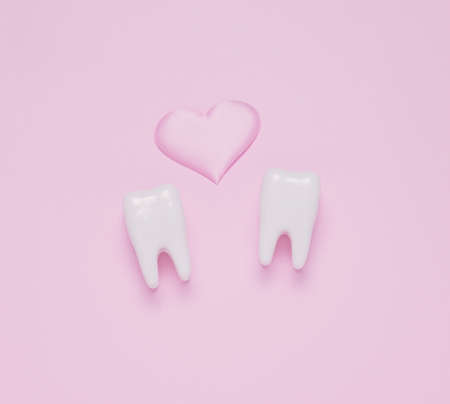 Top view flat lay Two teeth pink hearts pink pastel background. Oral care and St. Valentine's day concept.の写真素材