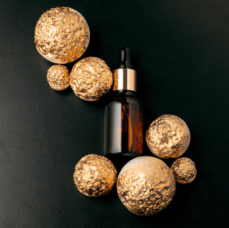 Top view flat lay natural oil mock up bottle with golden set design on black background, luxury cosmetics product.の写真素材