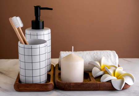 Toiletries composition on marble table against brown wall. spa concept.の写真素材