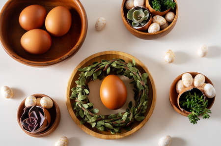 Top view Easter composition on a white table. Brown eggs and succulents in egg.の写真素材