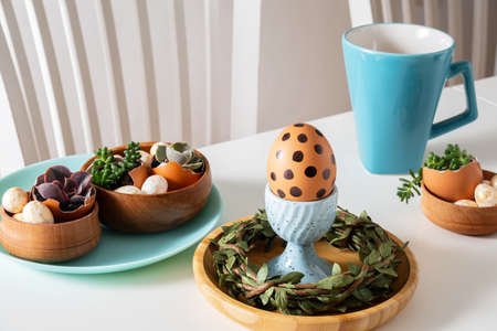 Easter set holiday table. White table with egg with polka dot on egg stand and easter decorations.の写真素材