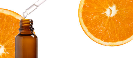 Pipette with organic citrus oil and orange slices on white background. Wide website banner. cosmetic product banner.の写真素材