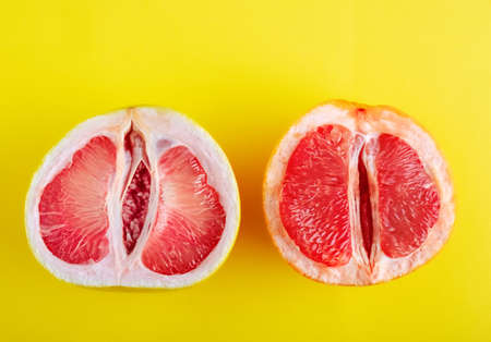 Top view pomelo fruit and grapefruit halves on yellow background.の写真素材