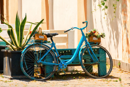 Cute blue bike with baskets with flowers in old town Tbilisi, Georgia.の写真素材