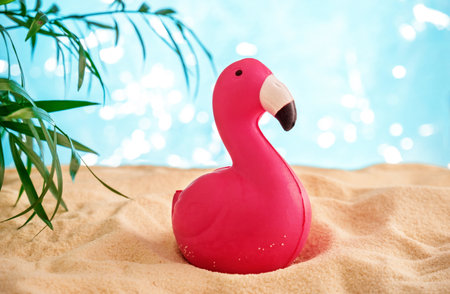 CUte funny pink flamingo on a sandy beach.の写真素材