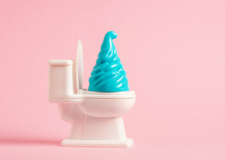 Toilet bowl with blue swirl on a pink background.の写真素材