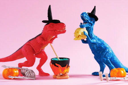 Red and blue dinosaur brewing potion on pink background.の写真素材