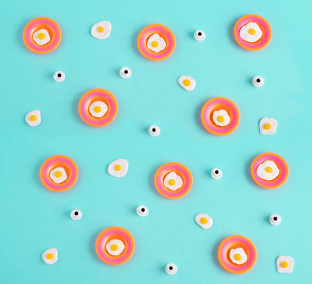 Top view flat lay miniature fried eggs and coffee cups on pastel blue background.の写真素材