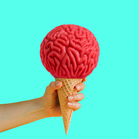Female hand holding waffle cone ice cream with ice cream made from human brain. Creative art poster...