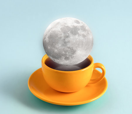 Creative art collage with full moon in coffee cup on blue background.の写真素材