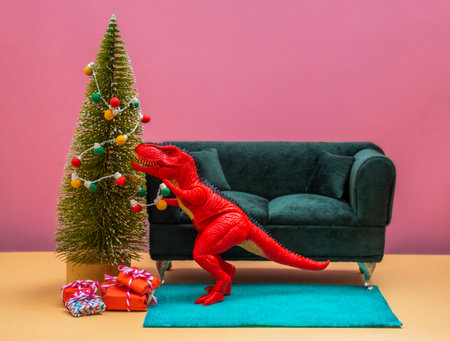 Happy cute red dinosaur decorate Christmas tree with retro bulb garland. Christmas and new year greeting card.の写真素材