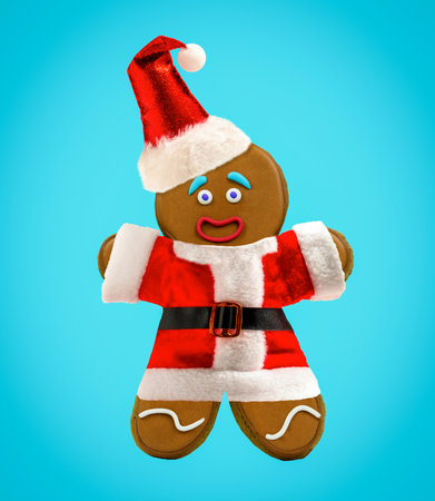Happy gingerbread man cookie wearing Santa Claus costume on blue background. Winter holidays minimal...
