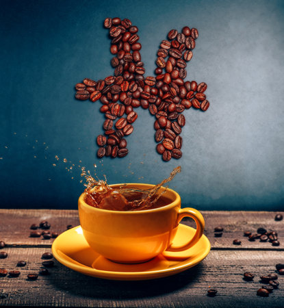 Pisces zodiac sign above coffee mug on dark background. Astrology creative still life.の写真素材