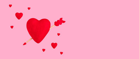 Red hearts on pastel pink background. Wide banner. Copy space.の写真素材